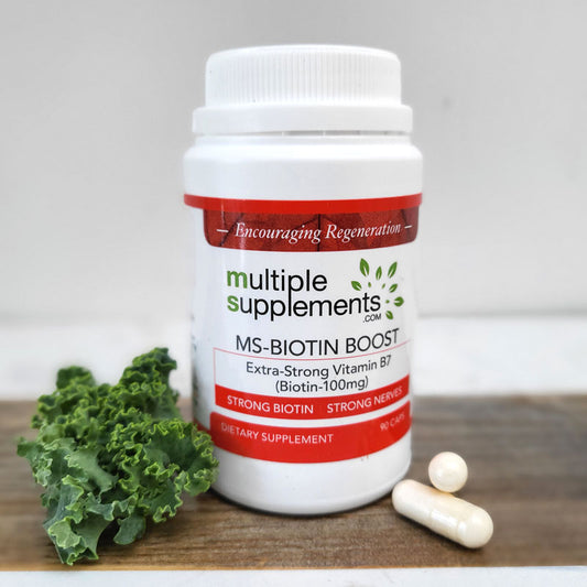 MS-Biotin Boost supplement bottle with "Extra-Strong Vitamin B7 (Biotin-100mg)" label, shown with one capsule and kale.